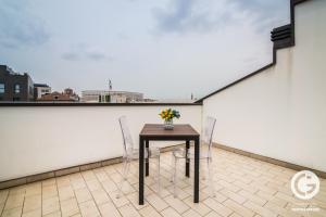 a table and two chairs on a balcony at YPApartments FIERA in Padova