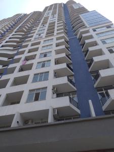 a tall white apartment building with balconies at Apartament DeLux Sea View in Batumi