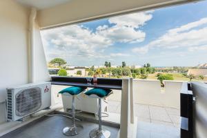 a view from a balcony with two stools at Zen et Summer Zen coursive naturiste in Cap d'Agde