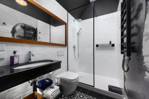 a bathroom with a toilet and a sink and a shower at Hothel in Hel +46 photos