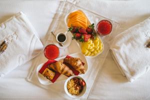 a tray of food with different types of food on it at Jazz Hotel in Olbia