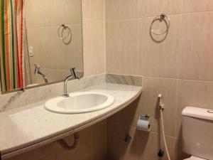 a bathroom with a sink and a mirror and a toilet at Coco Beach Apart 5B in Natal +29 photos
