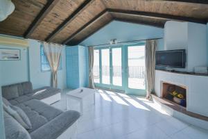 a living room with a couch and a fireplace at Kazanegra Exclusive Apartments in Sveti Stefan
