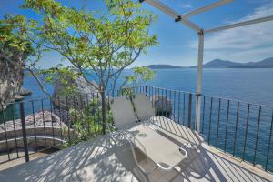 a balcony with a view of the water at Kazanegra Exclusive Apartments in Sveti Stefan