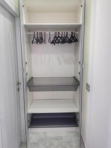 a refrigerator with empty shelves in a room at Cozy & Stylis at Center cty Bahai gardens street in Haifa