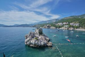 a small island in the middle of a body of water at Kazanegra Exclusive Apartments in Sveti Stefan