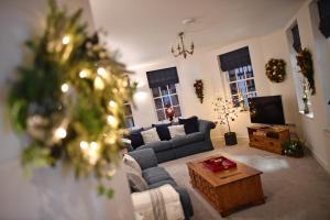 a living room with a couch and a tv at No 3 Central Chambers in Stratford-upon-Avon