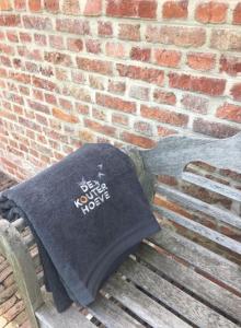 a tshirt sitting on a bench next to a brick wall at De Kouterhoeve in Moorslede