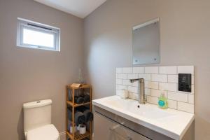 a bathroom with a sink and a toilet at The Old Engineer A rural boutique retreat in Yalding +19 photos