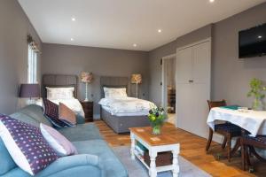 a living room with a couch and a bed at The Old Engineer A rural boutique retreat in Yalding