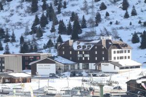 a town in the snow with a ski lift at Savoia Hotel in Passo del Tonale