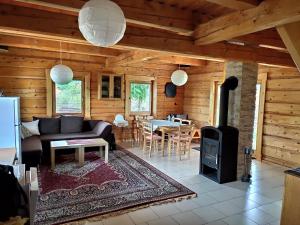 a living room with a couch and a stove at Drevenica Hrabušice in Hrabušice