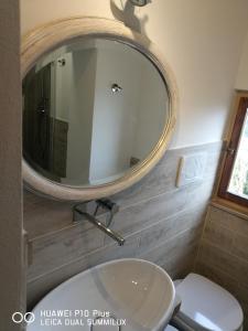 a bathroom with a sink and a mirror on the wall at Toscanamente in Volterra