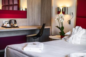 Ένα ή περισσότερα κρεβάτια σε δωμάτιο στο Jazz Hotel