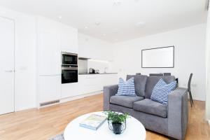 a living room with a couch and a table at Clover Court in London