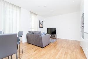 a living room with a couch and a television at Clover Court in London