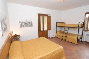 a bedroom with two beds and a bunk bed at Le antiche Torri in Pescasseroli