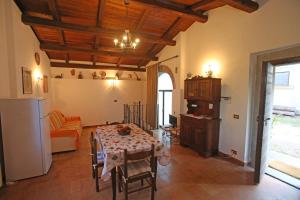 a kitchen and dining room with a table and a couch at La viola in Bomarzo +46 photos