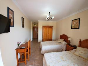 A bed or beds in a room at Hotel Arco del Sol