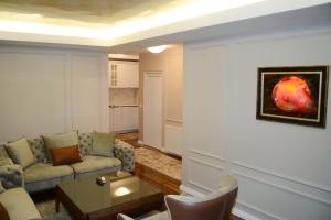 a living room with a couch and a table at Hotel Begolli in Prishtinë