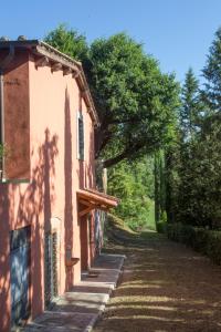 a building with a shadow on the side of a road at La viola in Bomarzo
