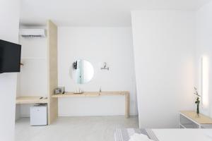 a white room with a sink and a mirror at NC Boutique B&B in Torre San Giovanni Ugento +40 photos