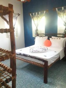 Кровать или кровати в номере Carpe Diem Nungwi