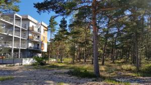 an apartment building with trees in the foreground at Apartament Baltic Relax in Rowy
