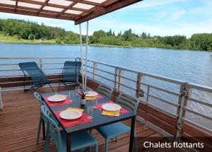 a table and chairs on the deck of a boat at VVF Corrèze Pays d'Eygurande in Eygurande