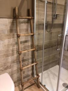 a bamboo ladder in a bathroom with a shower at Le Stanze del Borgo in Nettuno