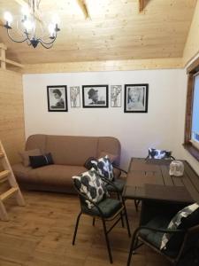 a living room with a couch and a table at Babie Lato in Włodarka