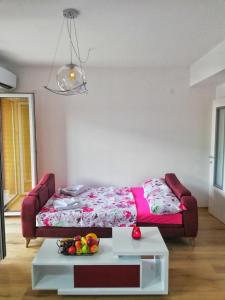 a living room with a bed and a table at Apartment Maris in Ohrid