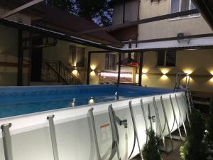 a swimming pool with lights on the side of a building at Club-Hotel Flagman in Bishkek