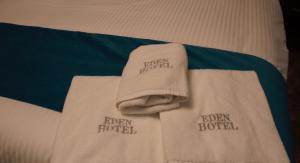 a white towel laying on top of a bed at Eden Hotel in Beirut