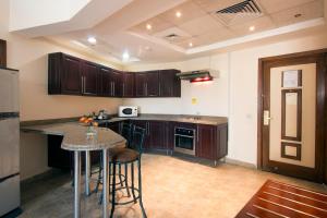 A kitchen or kitchenette at Swiss Inn Plaza Hotel