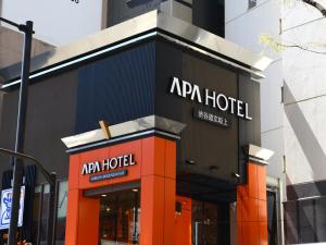 
a large building with a sign on the side of it at APA Hotel Shibuya Dogenzakaue in Tokyo

