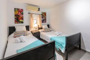 a bedroom with two beds and a mirror at Villa Benirrás in Sant Miquel de Balansat