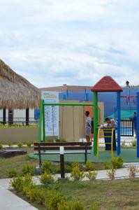 a park with a playground with a swing at CASA VACACIONAL CONDOMINIO BAHÍA SOLERO in Girardot