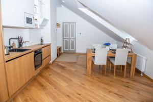 - une cuisine et une salle à manger avec une table et des chaises dans l'établissement Lossi 32 Penthouse, à Tartu