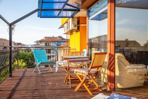 eine Terrasse mit Stühlen und Tischen auf dem Balkon in der Unterkunft Nessebar's NEW Town / TOP Centre / 2-BDR Apartment in Nessebar