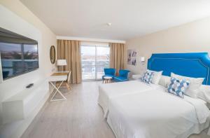 a hotel room with a large bed and a desk at Hotel Boutique TAO Caleta Mar in Corralejo +37 photos