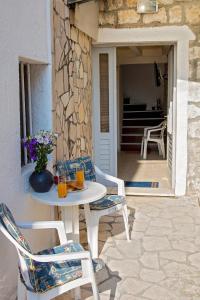 a patio with a table and chairs on a patio at Stone House Grgurevic in Rogoznica
