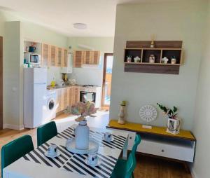 a kitchen with a table and a dining room at Brickyard Apartments Cluj in Cluj-Napoca