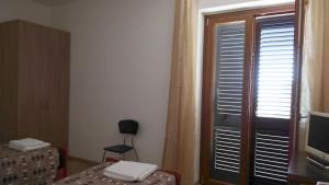 a room with a window with a television and a bed at Valdagri BnB in SantʼArcangelo