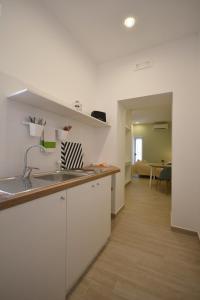 a kitchen with a sink and a counter top at Flower house in Santa Maria La Carità
