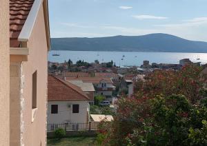 a view of a city and the water from a building at Apartmani Kankaras - Sea View in Tivat