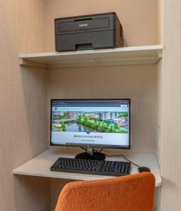 a computer monitor and keyboard on a shelf at Bridgewater Hotel, Trademark Collection by Wyndham in Fairbanks
