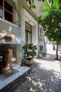 a store front with a dress in a store window at "Cultural Athens" Kolonaki, Syntagma in Athens