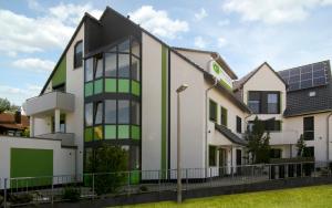 a house with solar panels on the side of it at Eco Smart Apartments Nürnberg Süd in Nürnberg