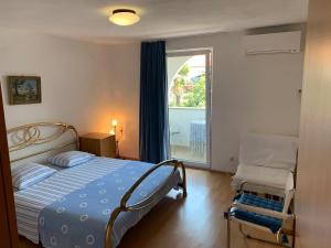 a bedroom with a bed and a large window at Arthouse Villa Palma in Poreč